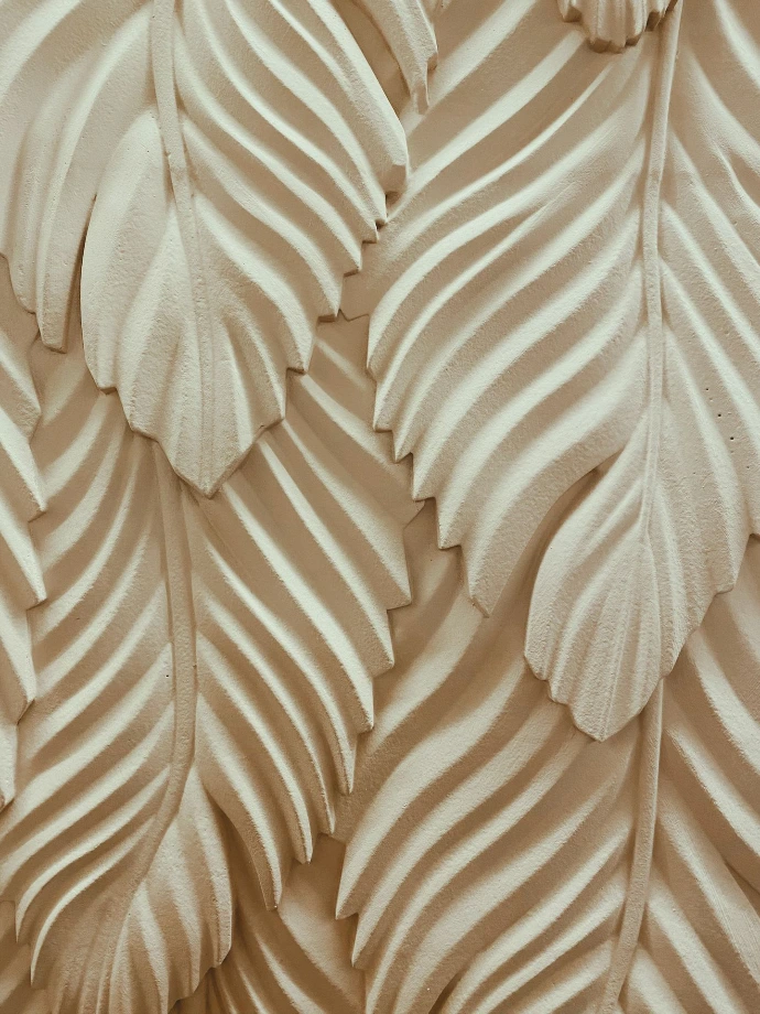 close view of white engraved leaves
